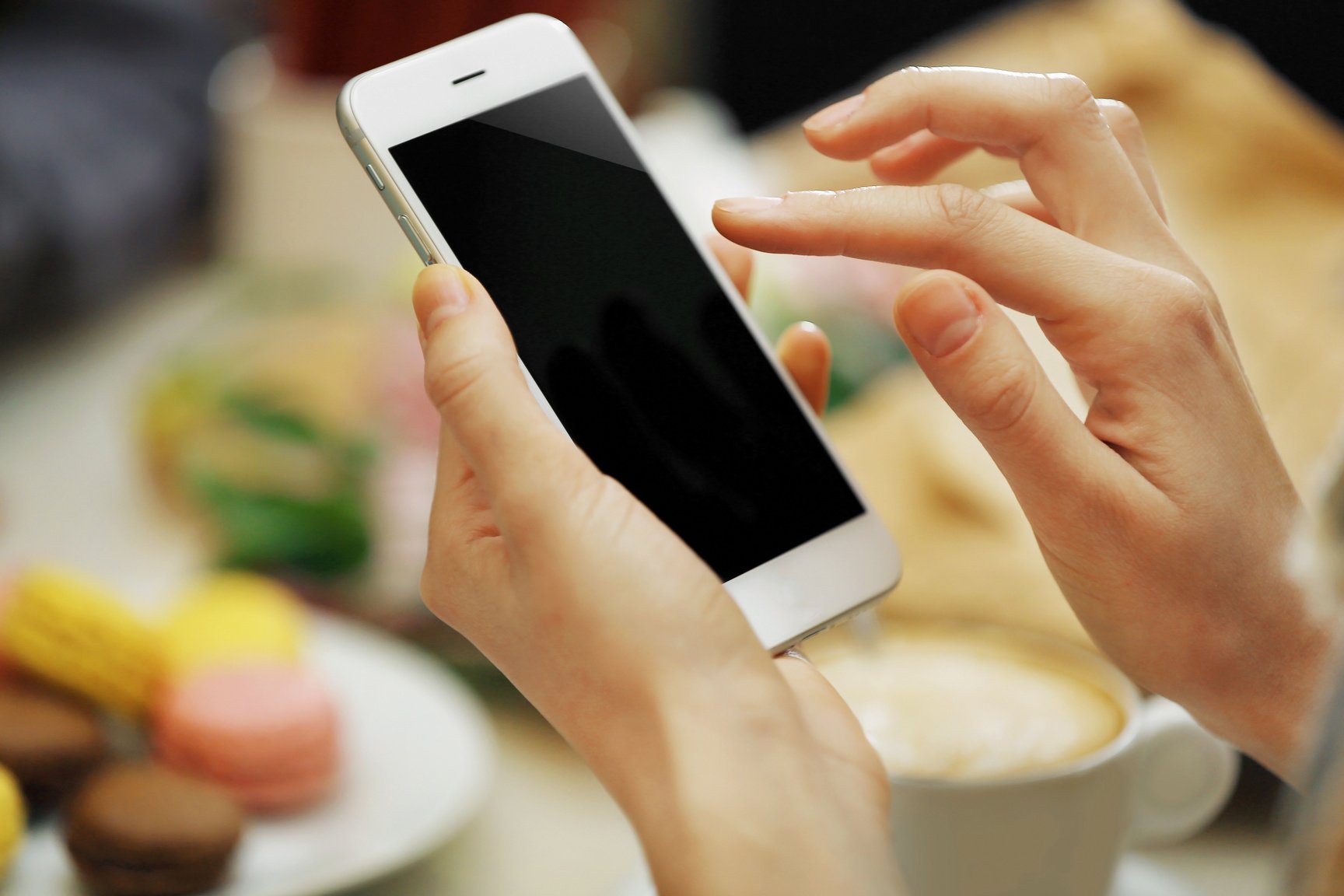 Woman Taking Photo of Food in Cafe